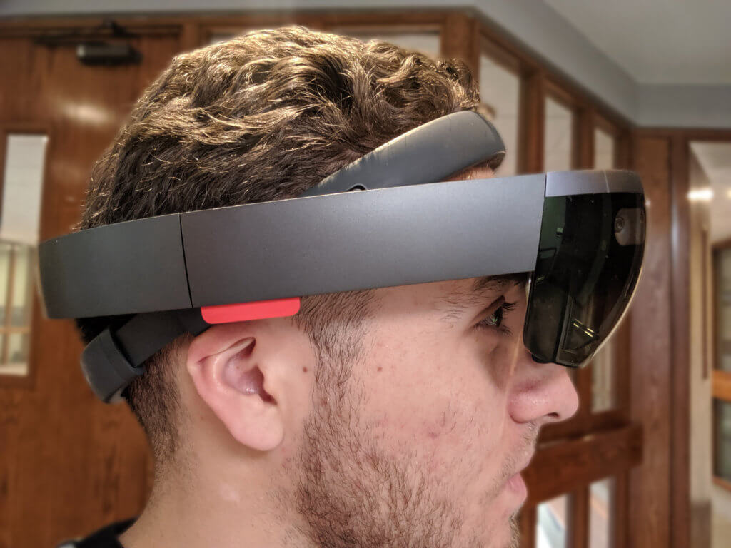 Side shot of Sergio wearing HoloLens Generation 1